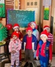 Children in Santa hats at the Christmas celebration
